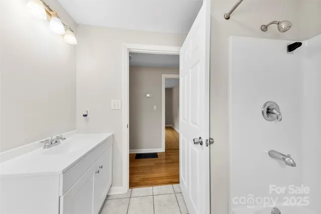 a bathroom with a sink a mirror and shower