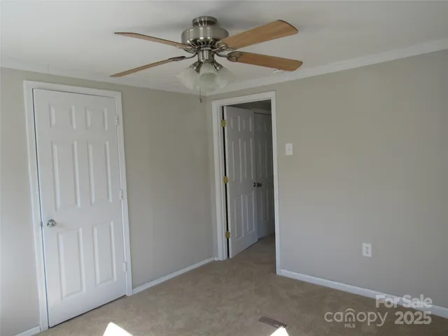 a view of a livingroom and a chandelier fan