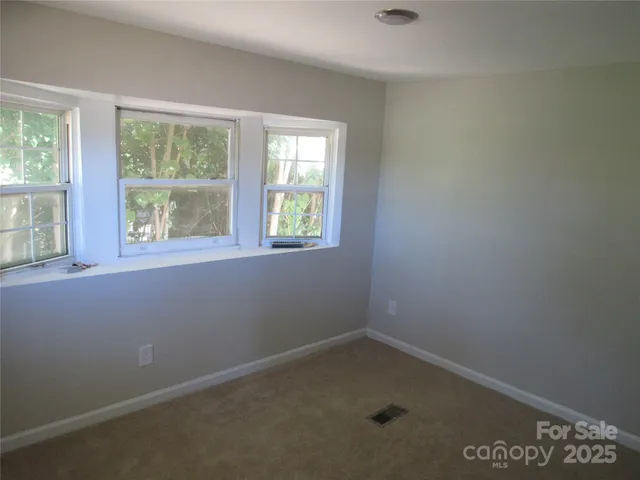 a view of a room that has a bed in it