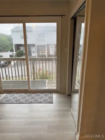 a view of porch with a floor to ceiling window and wooden floor