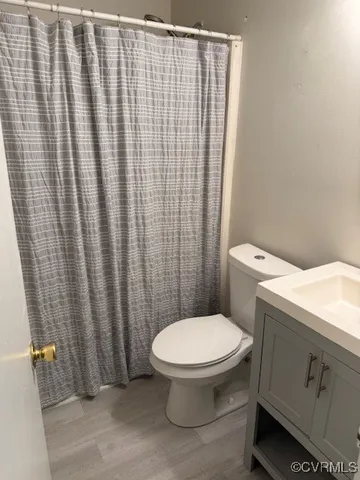 a white toilet sitting next to a shower curtain