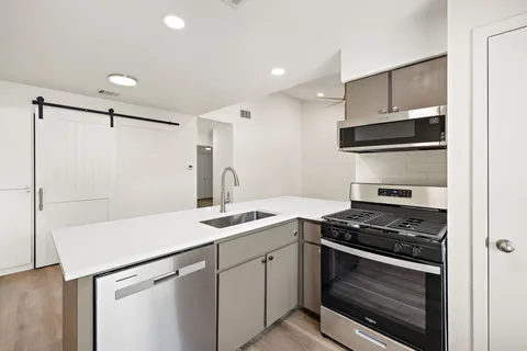 a kitchen with a sink stove and microwave
