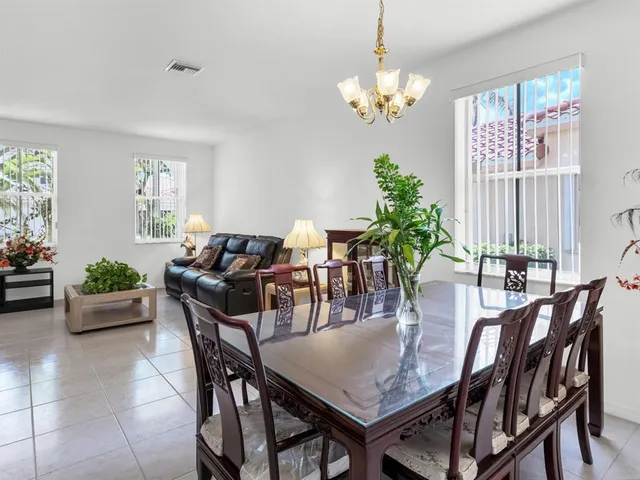 a kitchen with stainless steel appliances granite countertop a sink refrigerator stove and microwave