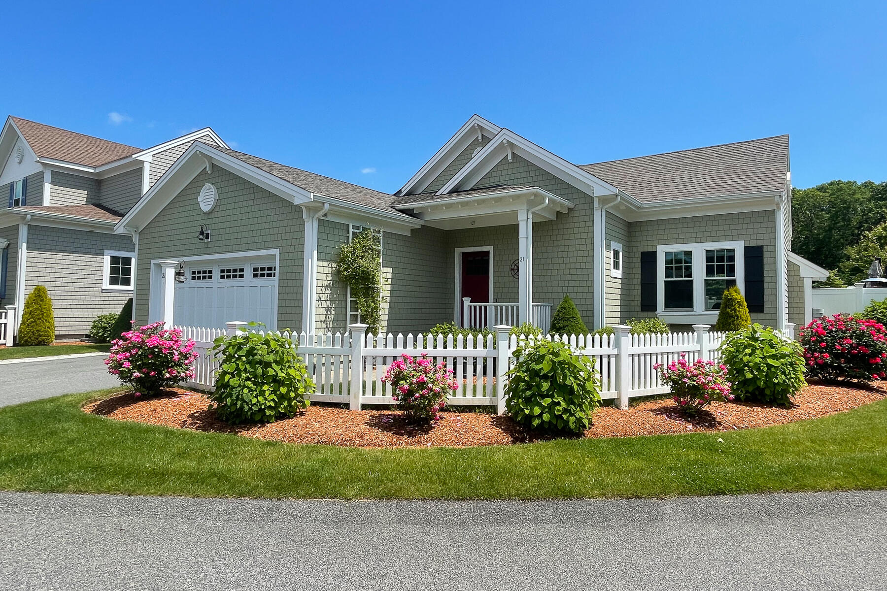 a front view of a house with a garden