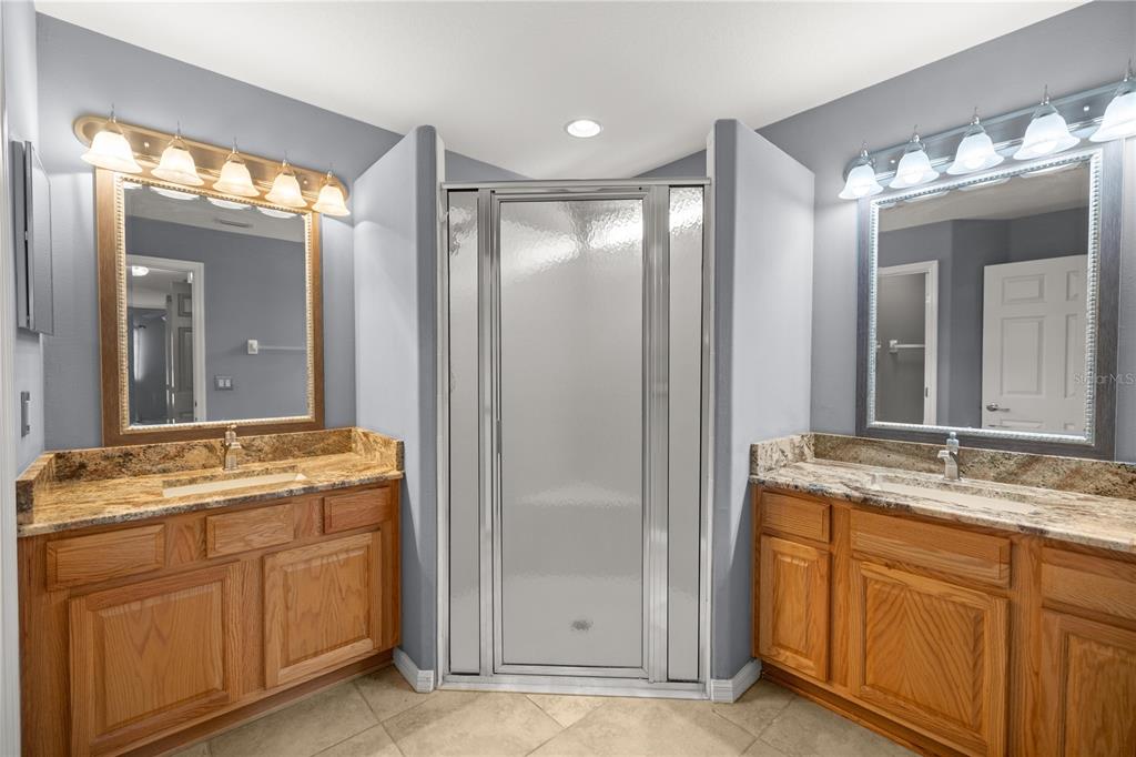 15813 Southwest 16th Avenue Road Ocala, FL 34473 - Photo 18 of 33 a bathroom with a granite countertop sink and a mirror