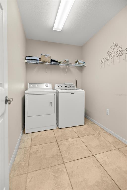 15813 Southwest 16th Avenue Road Ocala, FL 34473 - Photo 24 of 33 a utility room with cabinets dryer and washer