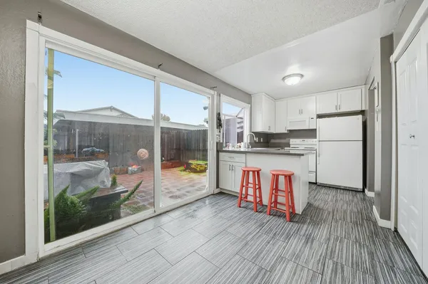 a kitchen with stainless steel appliances granite countertop a refrigerator and a stove top oven