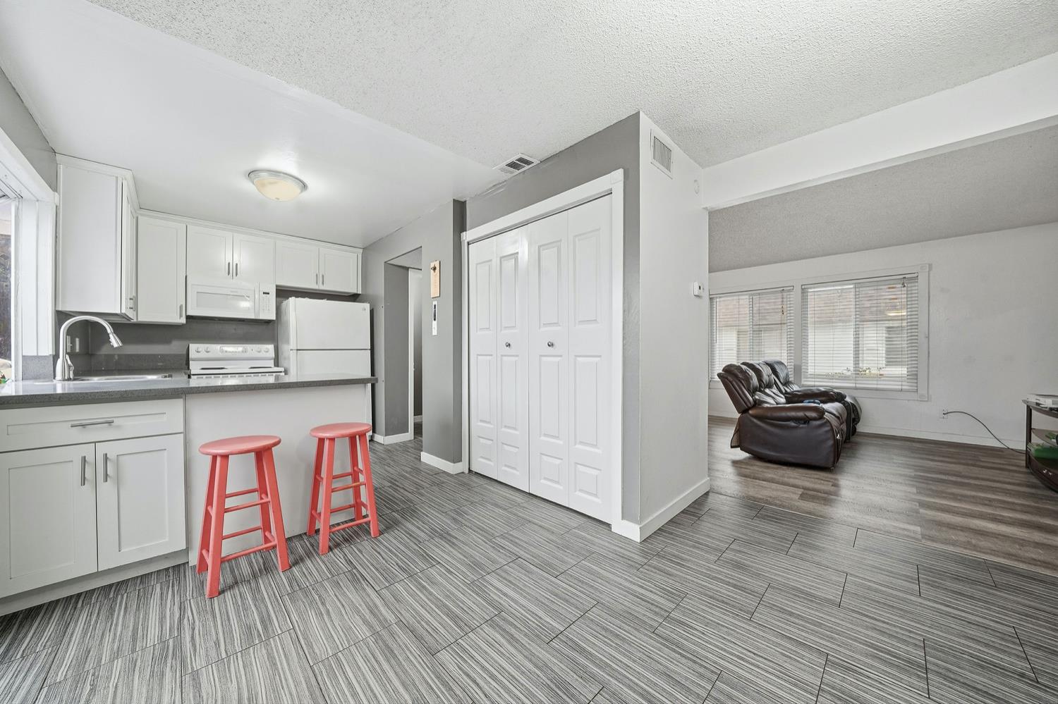 27 Omaha Court Sacramento, CA 95823 - Photo 9 of 43 a kitchen with kitchen island granite countertop a refrigerator and a sink
