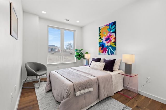 a bedroom with a bed and a chair