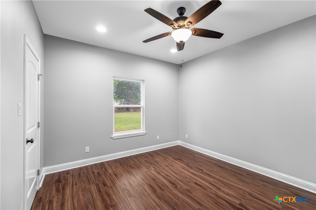 204 James Street Inez, TX 77968 - Photo 20 of 35 an empty room with a window and a ceiling fan
