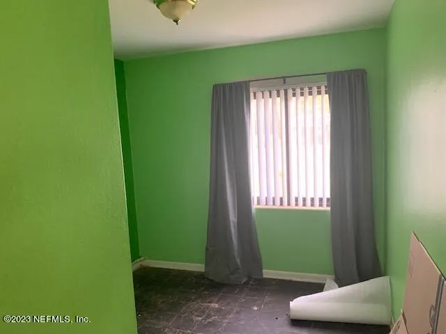 a room with window and a wooden door