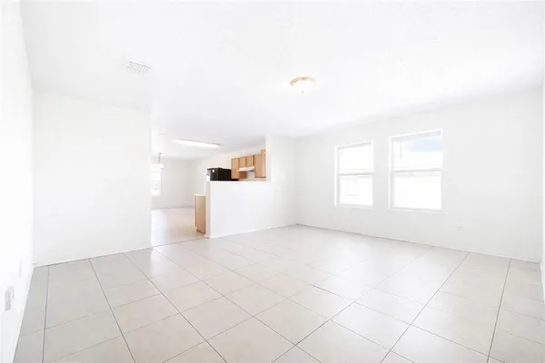 a view of a kitchen with white cabinets