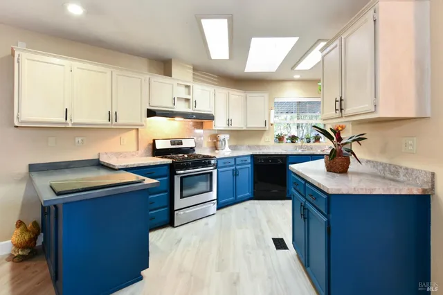 a kitchen with a sink a stove and cabinets