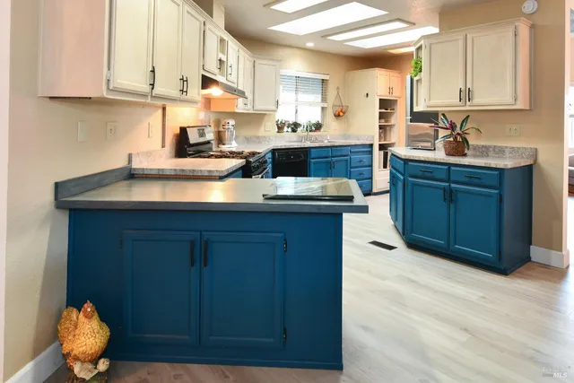 a kitchen with granite countertop a sink and cabinets