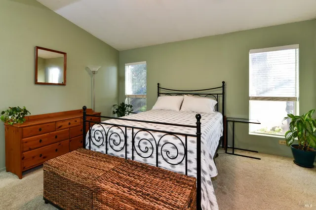 a bathroom with a double vanity sink a large mirror and shower