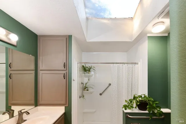 a bathroom with a sink a mirror and a toilet