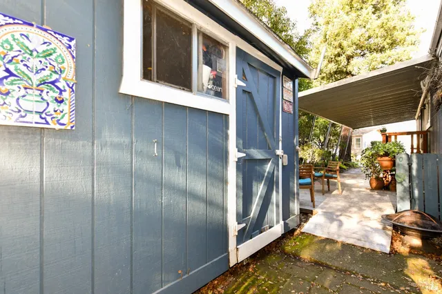 a backyard of a house with seating space and trees