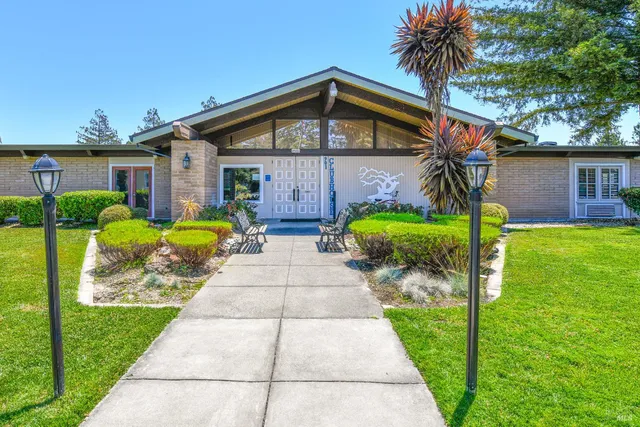 a room with pool table and windows