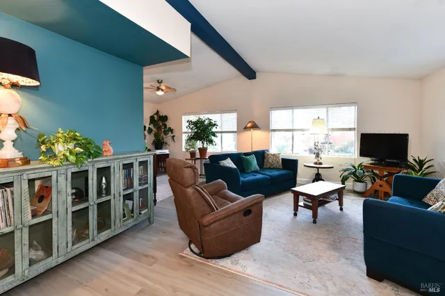a living room with furniture fireplace and a flat screen tv