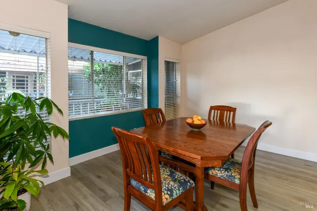 a view of a dining room with furniture window and wooden floor