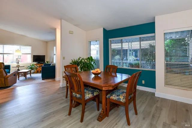 a view of a dining room with furniture window and wooden floor