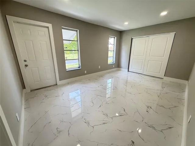 a bathroom with a double vanity sink toilet mirror and shower