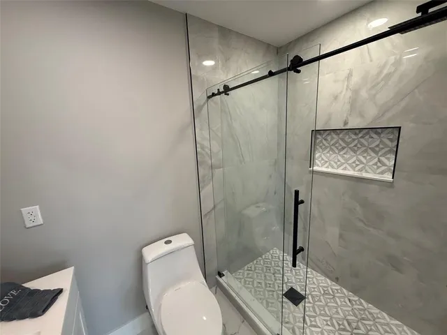 en empty room with windows and yard