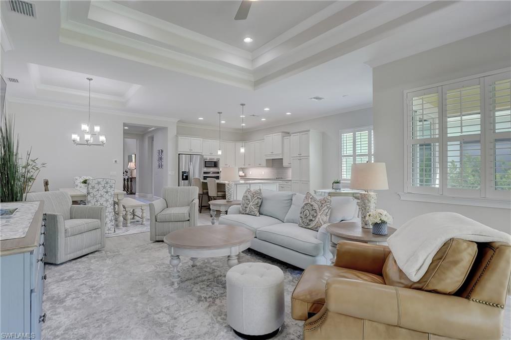 6297 Antigua Way Naples, FL 34113 - Photo 13 of 43 a living room with furniture and a large window