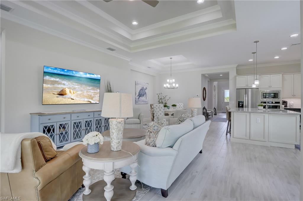 6297 Antigua Way Naples, FL 34113 - Photo 14 of 43 a living room with furniture and a view of kitchen