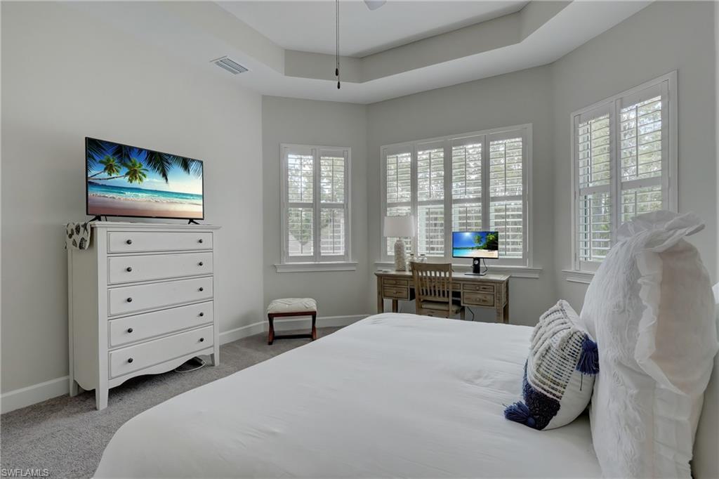 6297 Antigua Way Naples, FL 34113 - Photo 16 of 43 a bedroom with a bed and a window