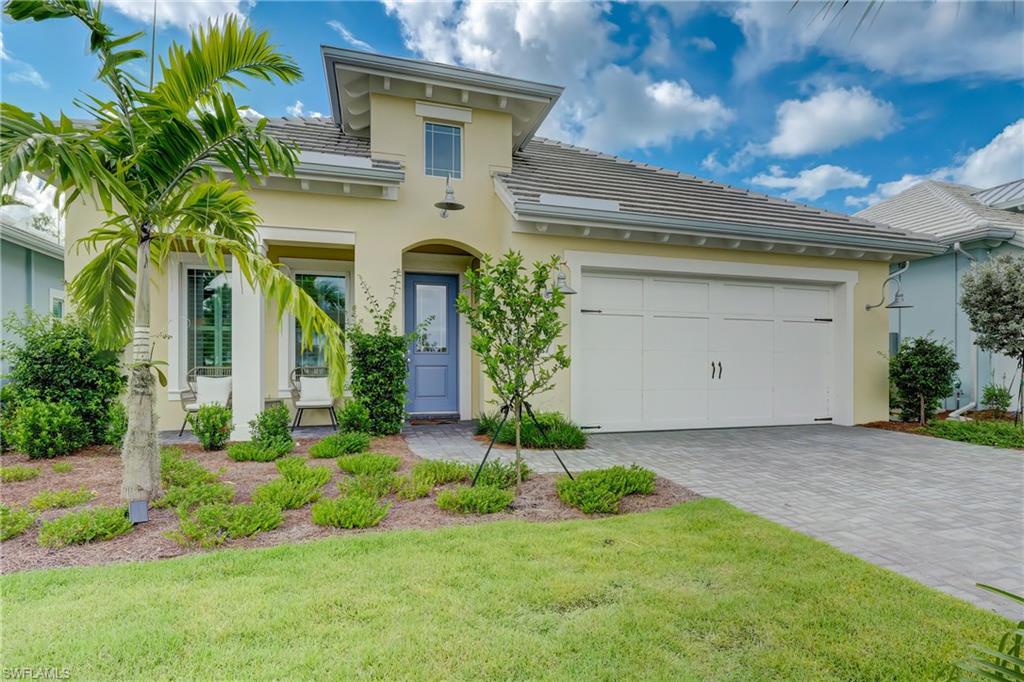 6297 Antigua Way Naples, FL 34113 - Photo 31 of 43 a front view of a house with garden