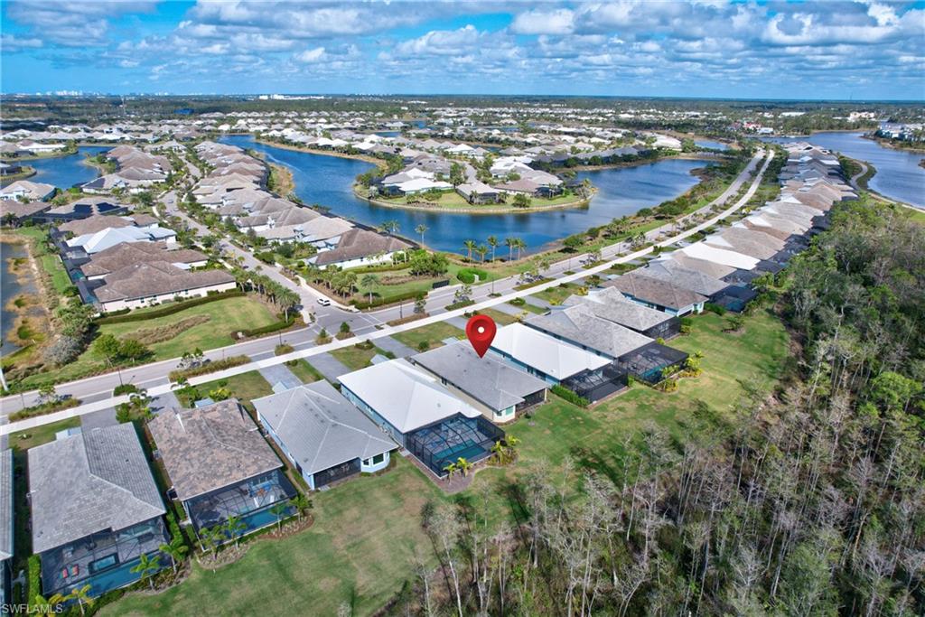 6297 Antigua Way Naples, FL 34113 - Photo 33 of 43 an aerial view of a house with a garden