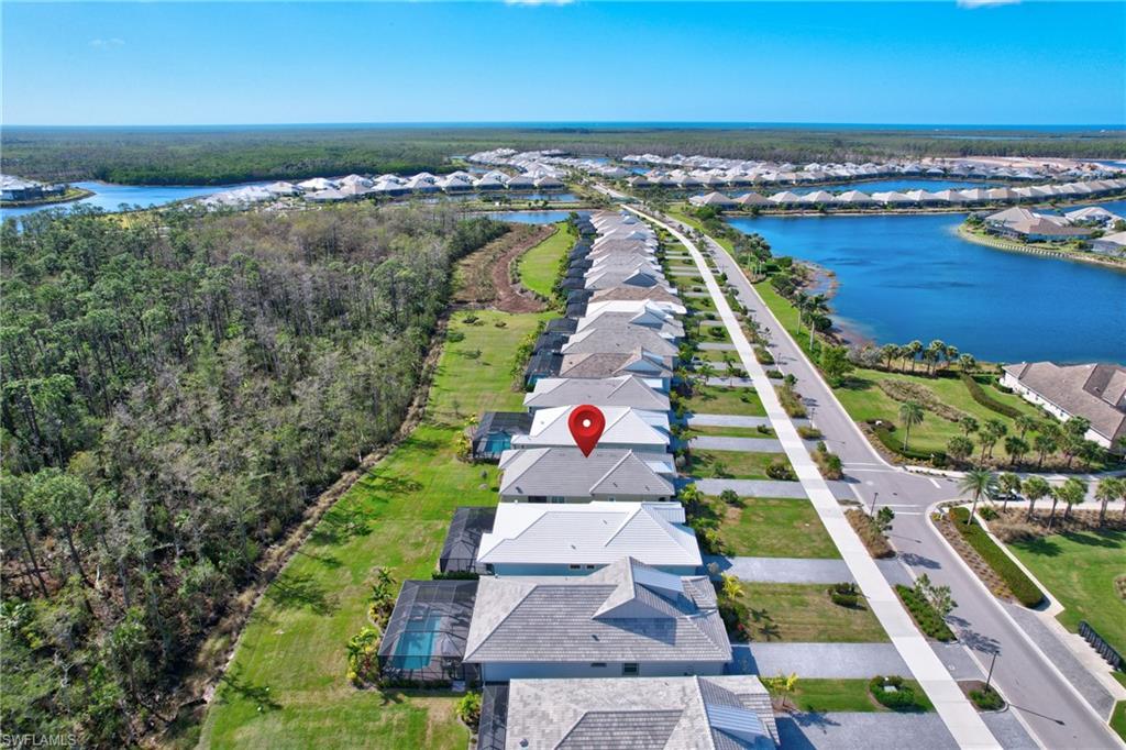 6297 Antigua Way Naples, FL 34113 - Photo 34 of 43 an aerial view of residential houses with outdoor space