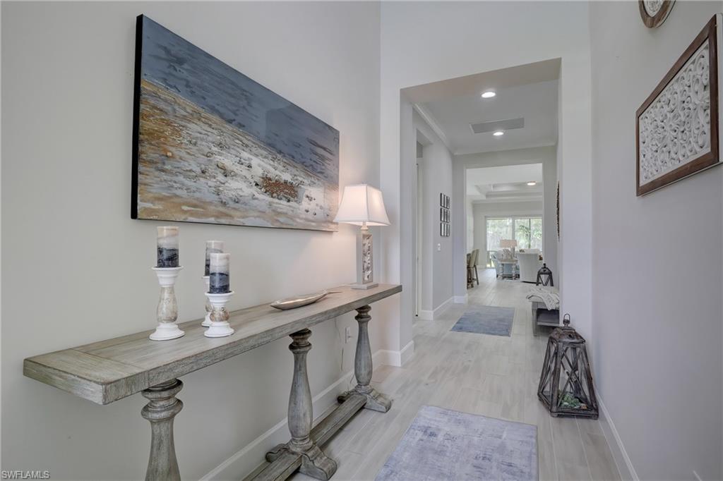 6297 Antigua Way Naples, FL 34113 - Photo 4 of 43 a room with gym equipment and view of living room