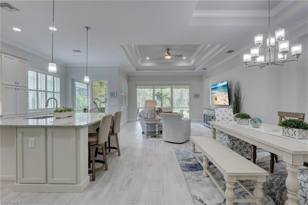 6297 Antigua Way Naples, FL 34113 - Photo 5 of 43 a large kitchen with a table and chairs