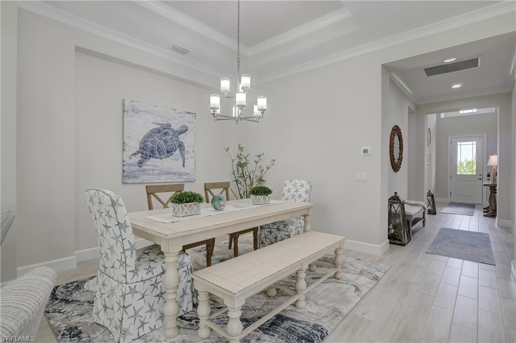 6297 Antigua Way Naples, FL 34113 - Photo 7 of 43 a view of a dining room with furniture and wooden floor