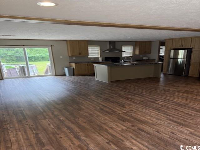 65 Clemmons Drive Tabor City, NC 28463 - Photo 29 of 29 Kitchen featuring ventilation hood, freestanding refrigerator, dark countertops, open floor plan, and dark wood finished floors