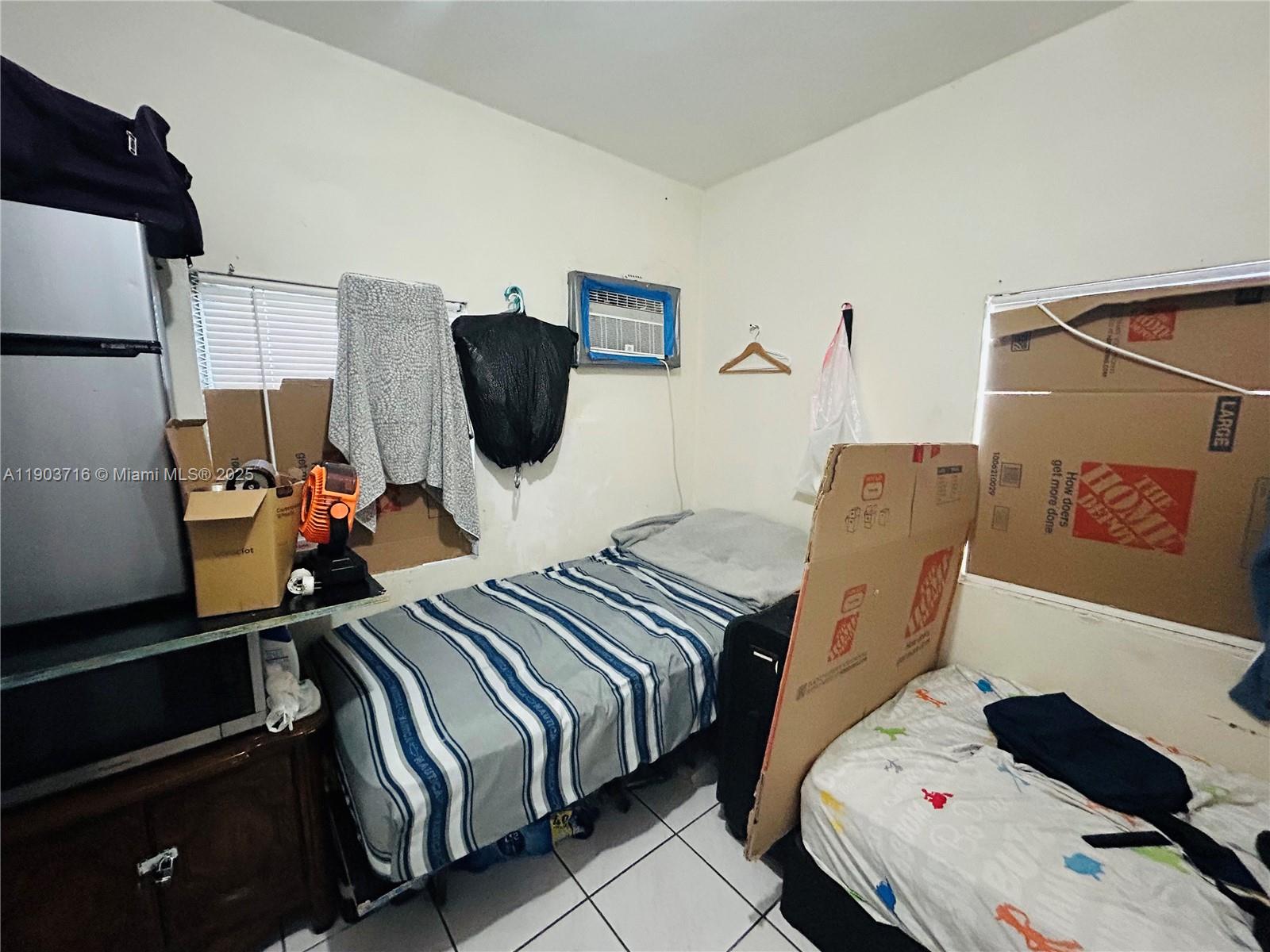 244 Southwest 36th Avenue Miami, FL 33135 - Photo 12 of 17 a bedroom with a bed and cabinets