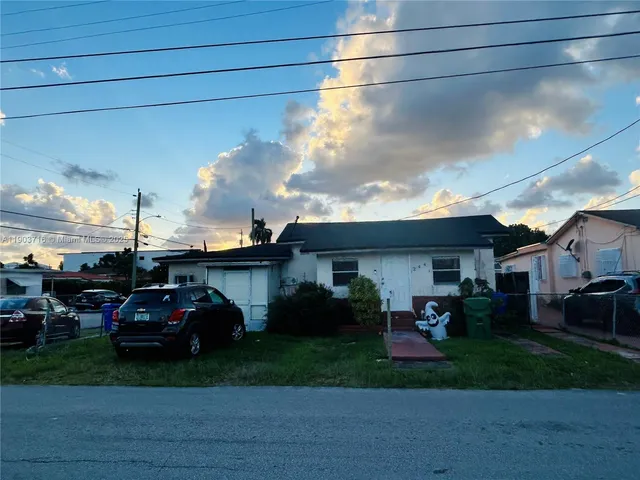 a view of a car parked in front of a house
