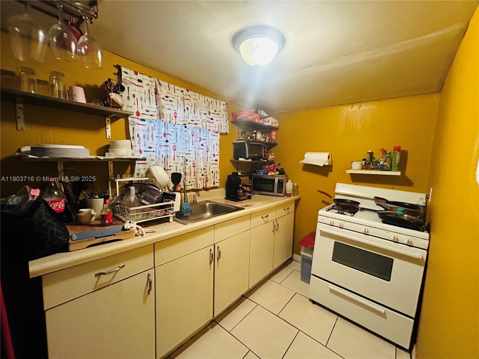 244 Southwest 36th Avenue Miami, FL 33135 - Photo 4 of 17 a kitchen with cabinets and appliances