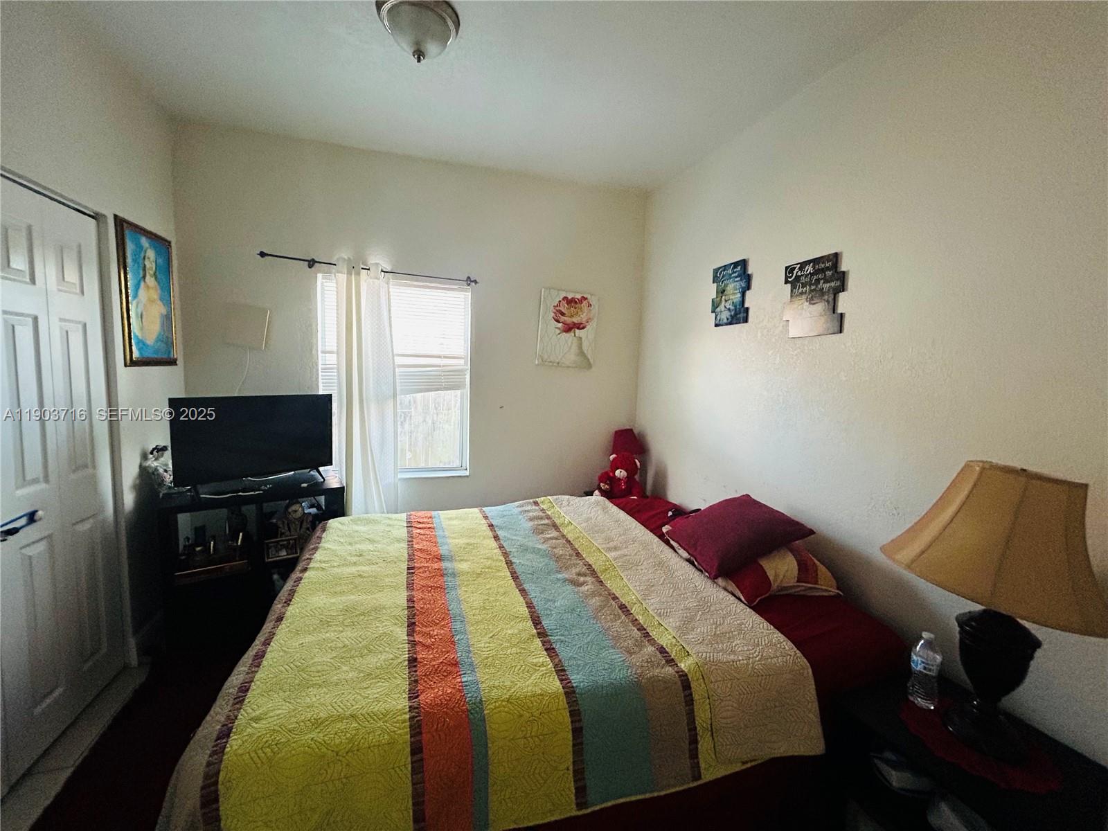 244 Southwest 36th Avenue Miami, FL 33135 - Photo 5 of 17 a bedroom with a bed and wooden floor