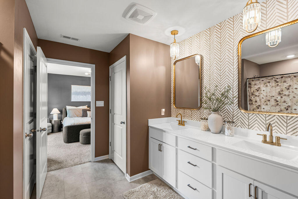7900 West 105th Place Crown Point, IN 46307 - Photo 16 of 33 a en suite bathroom with a double vanity sink and mirror