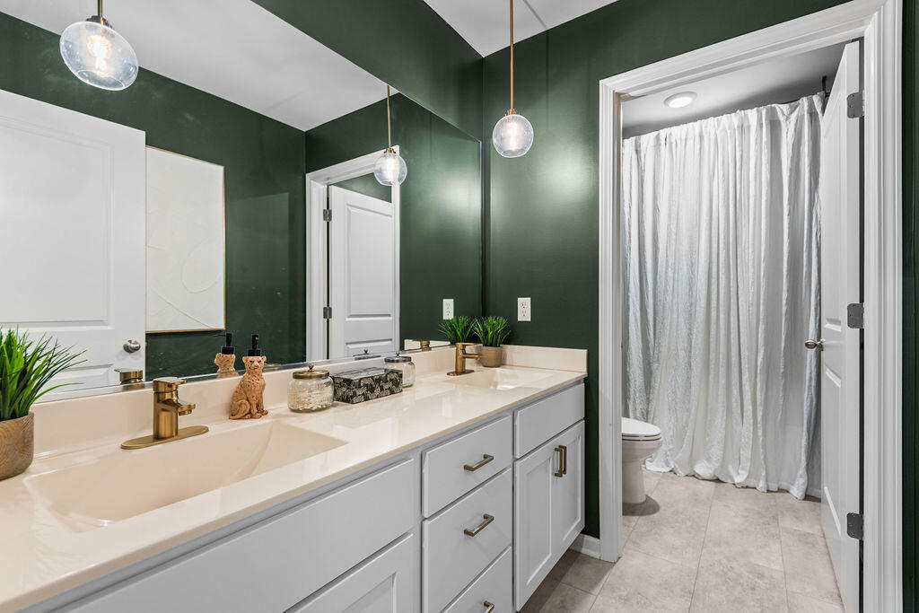 7900 West 105th Place Crown Point, IN 46307 - Photo 26 of 33 a bathroom with a double vanity sink and a mirror