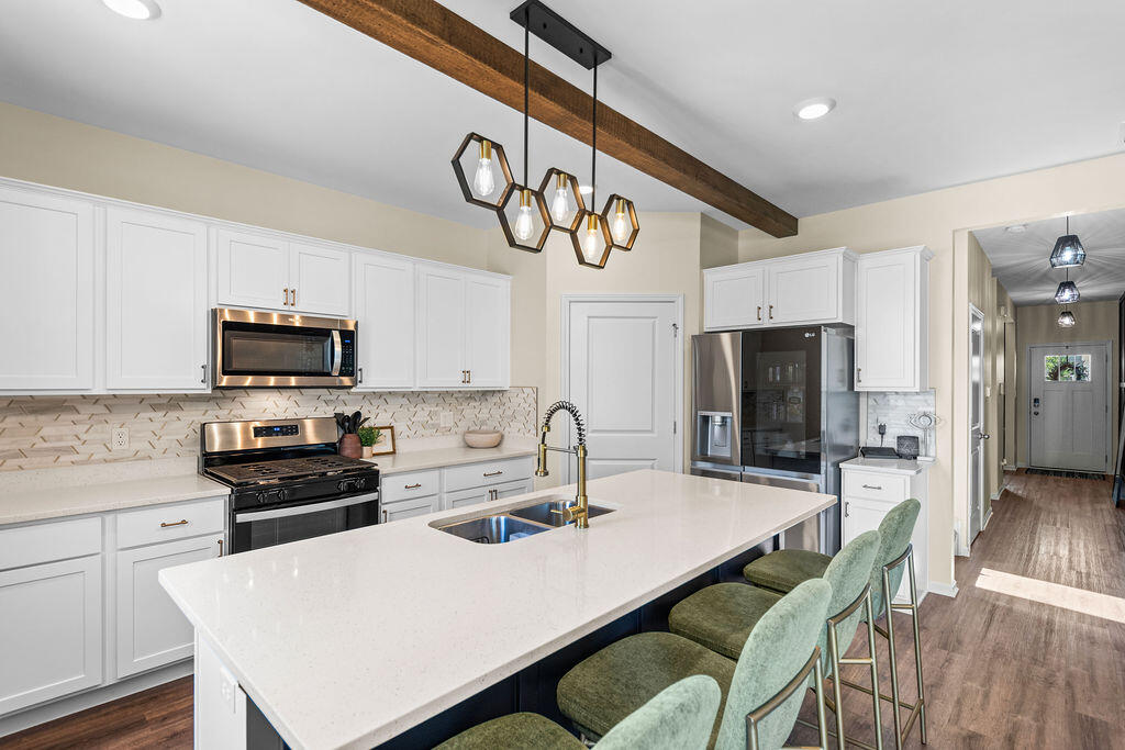 7900 West 105th Place Crown Point, IN 46307 - Photo 4 of 33 a kitchen with stainless steel appliances a table chairs and a refrigerator