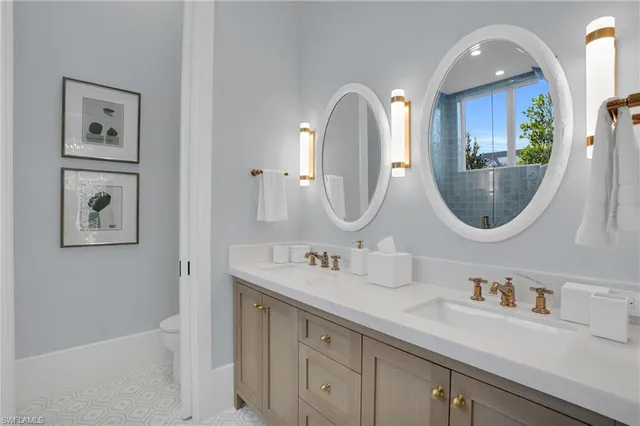 a bathroom with a double vanity sink and a mirror