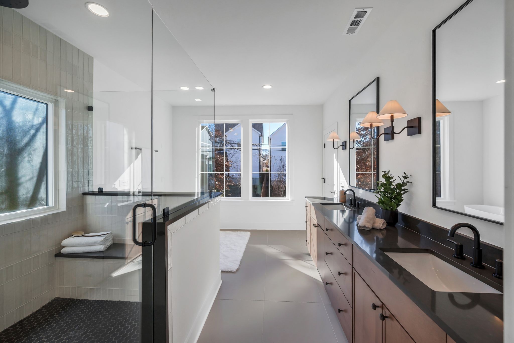605 A American Road Nashville, TN 37209 - Photo 16 of 36 a bathroom with a double vanity sink a mirror and a bathtub