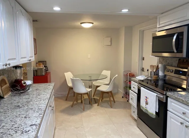 a kitchen with a stove a sink and a microwave