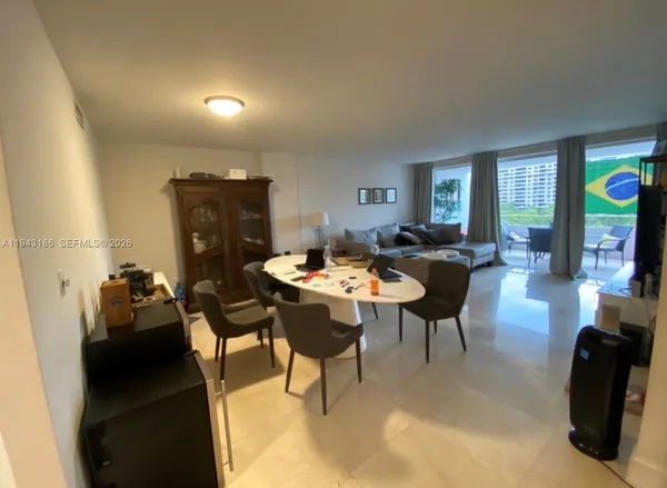 a living room with furniture a rug and a window