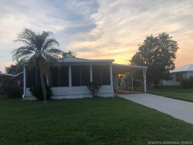 21 Los Lagos Road Port St. Lucie, FL 34952 - Photo 1 of 25 front view of a house with a yard and pathway