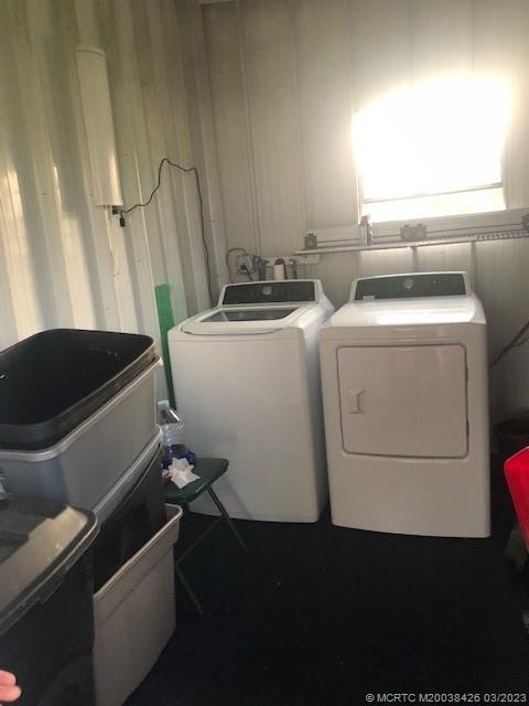 21 Los Lagos Road Port St. Lucie, FL 34952 - Photo 22 of 25 a utility room with dryer and washer
